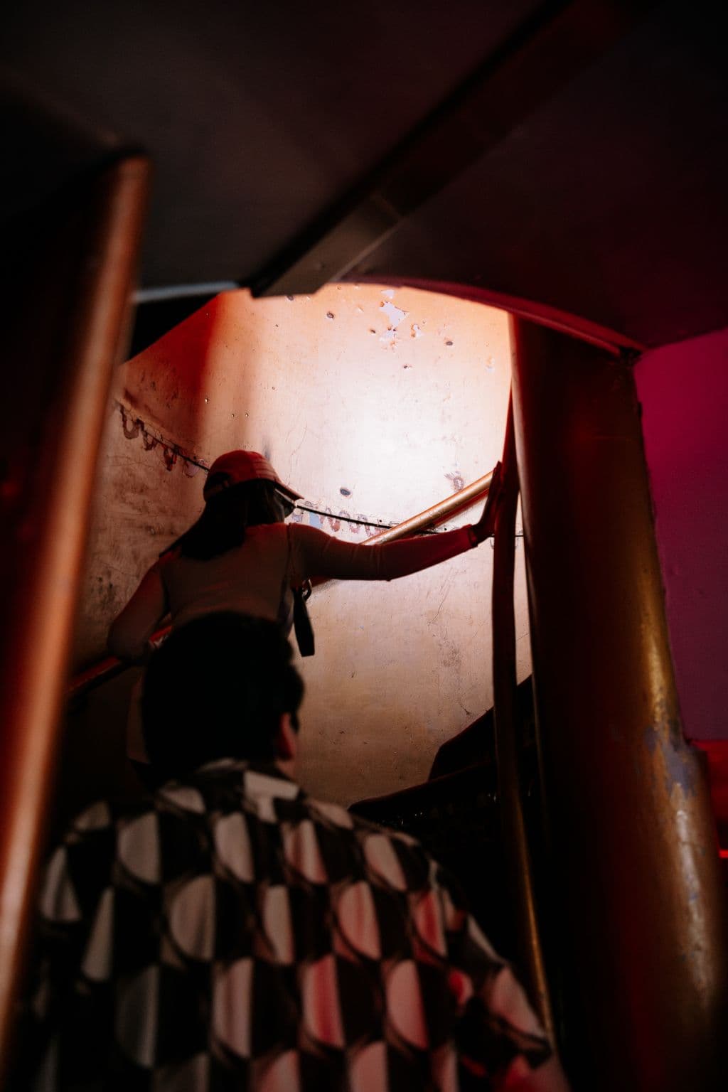 Guests climb the narrow industrial staircase toward the BUD stage