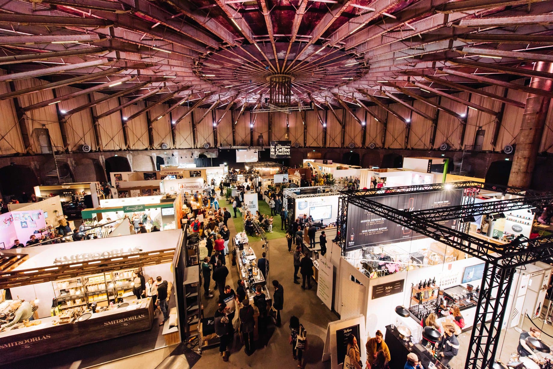 Amsterdam Coffee Festival filling the circular-roofed NDSM warehouse with stands and visitors